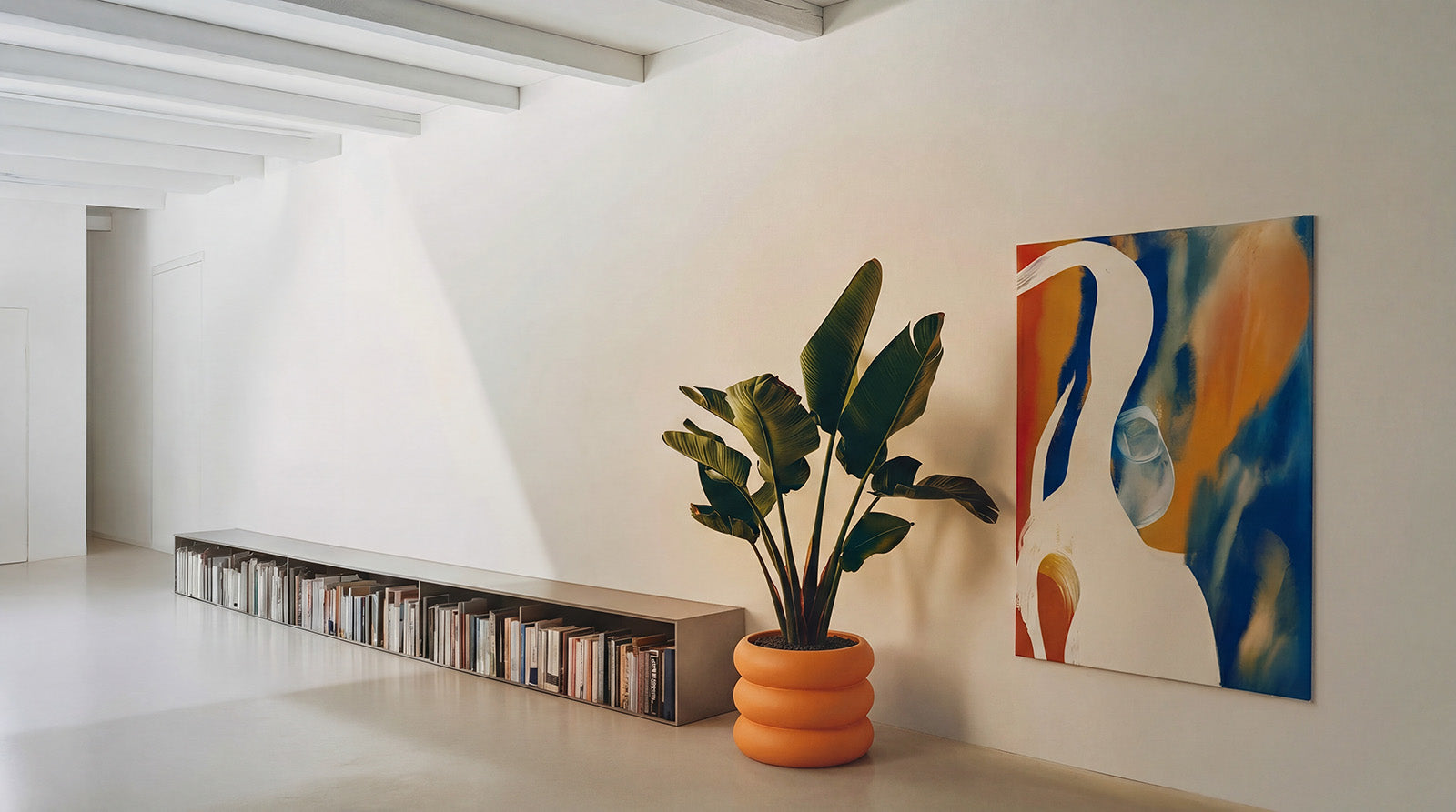 Modern interior with a plant, bookshelf, and abstract painting on a white wall.